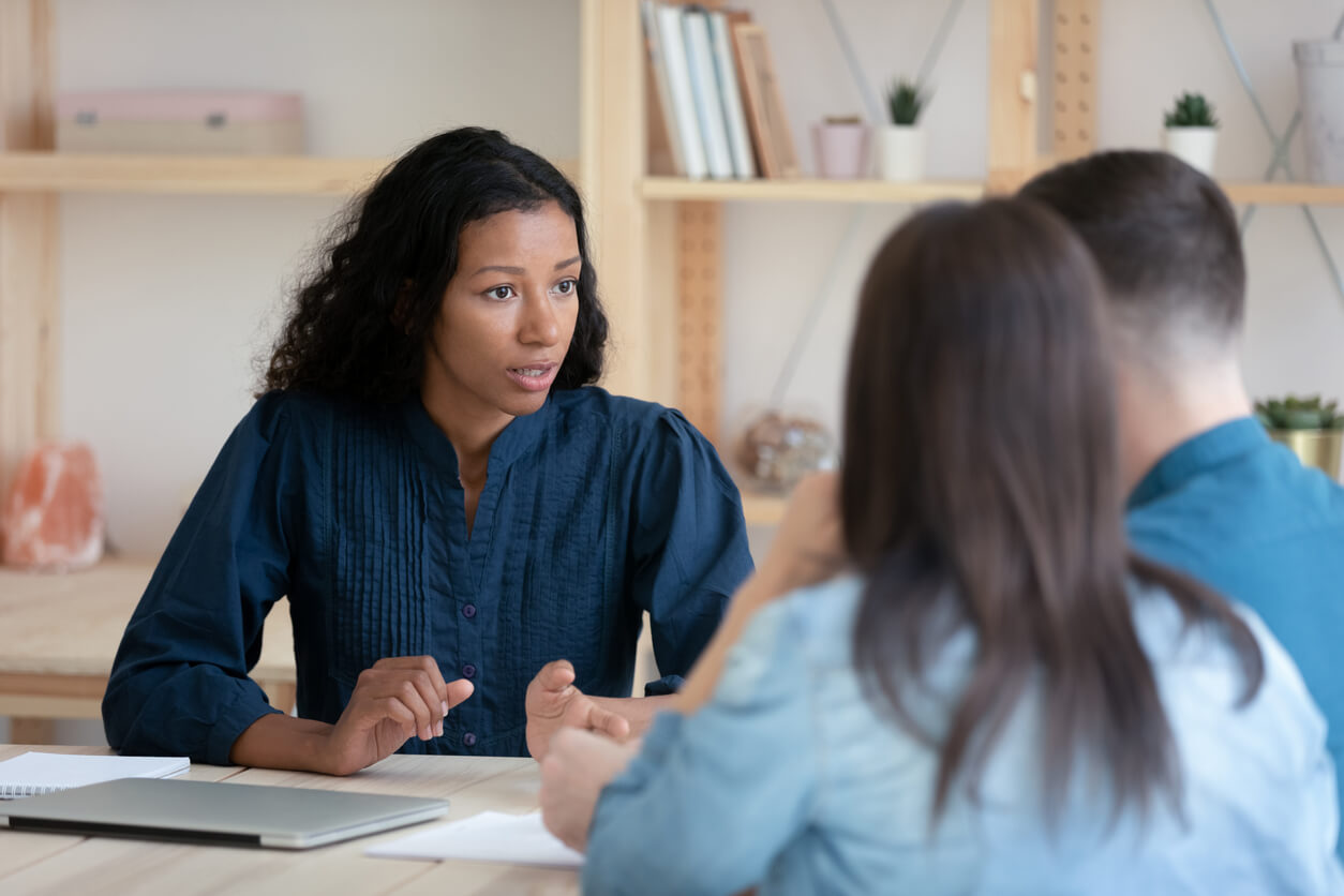 Bankruptcy attorney sitting with two clients