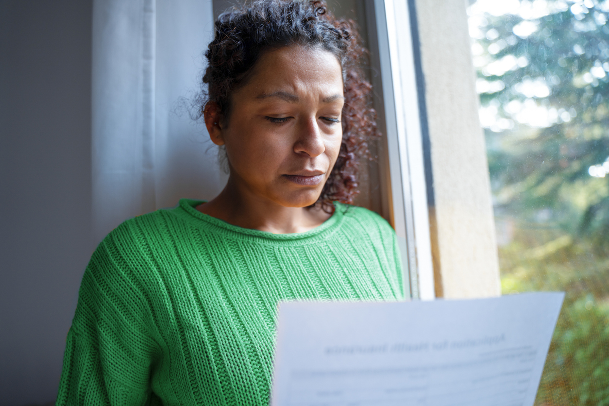 Black woman getting bad news letter of repossession and is feeling worried